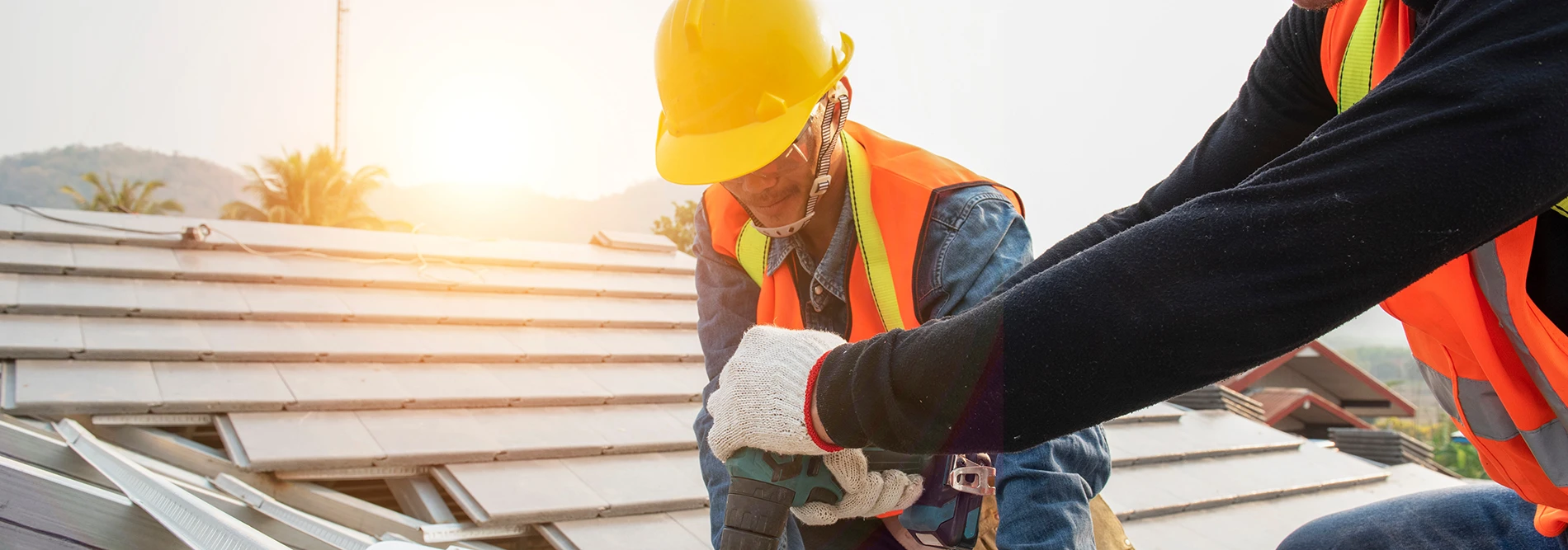 Construction workers on a roof working